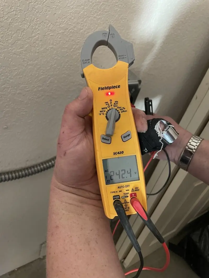 Voltage testing with clamp meter during Whole House Surge Protector in West Pensacola